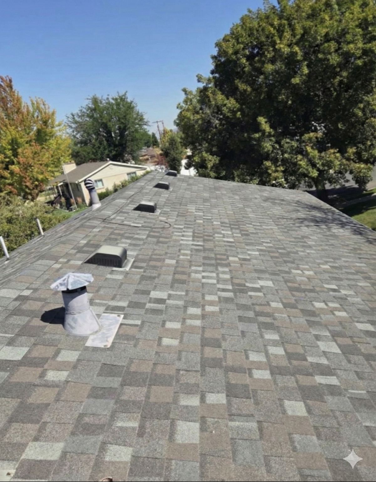 Grey asphalt shingle roof and gutter line on a Utah home