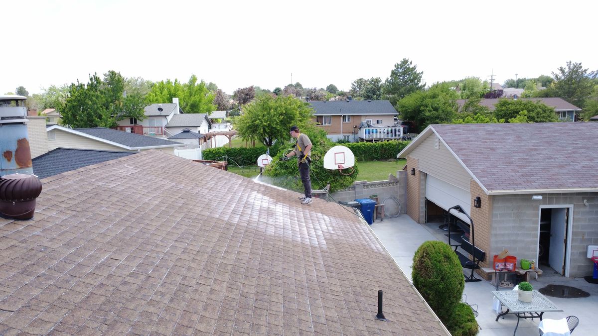 Drone view along the eave and gutter line of a Utah home during a Revive Your Roof visit