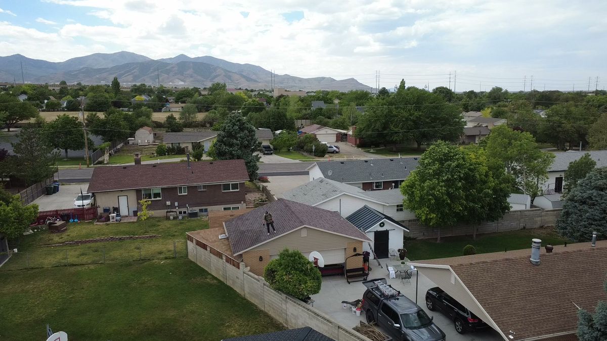 Aerial view over Salt Lake County rooftops with the Wasatch mountains on the skyline