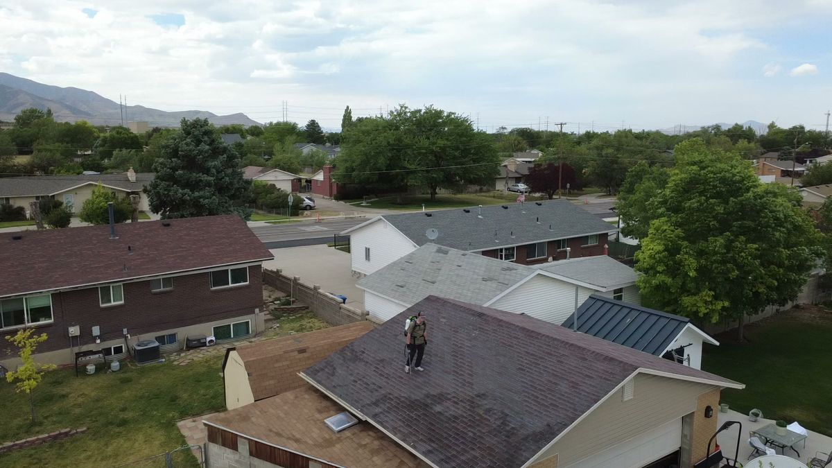 Aerial view of Weber County rooftops with open ground toward the Great Salt Lake
