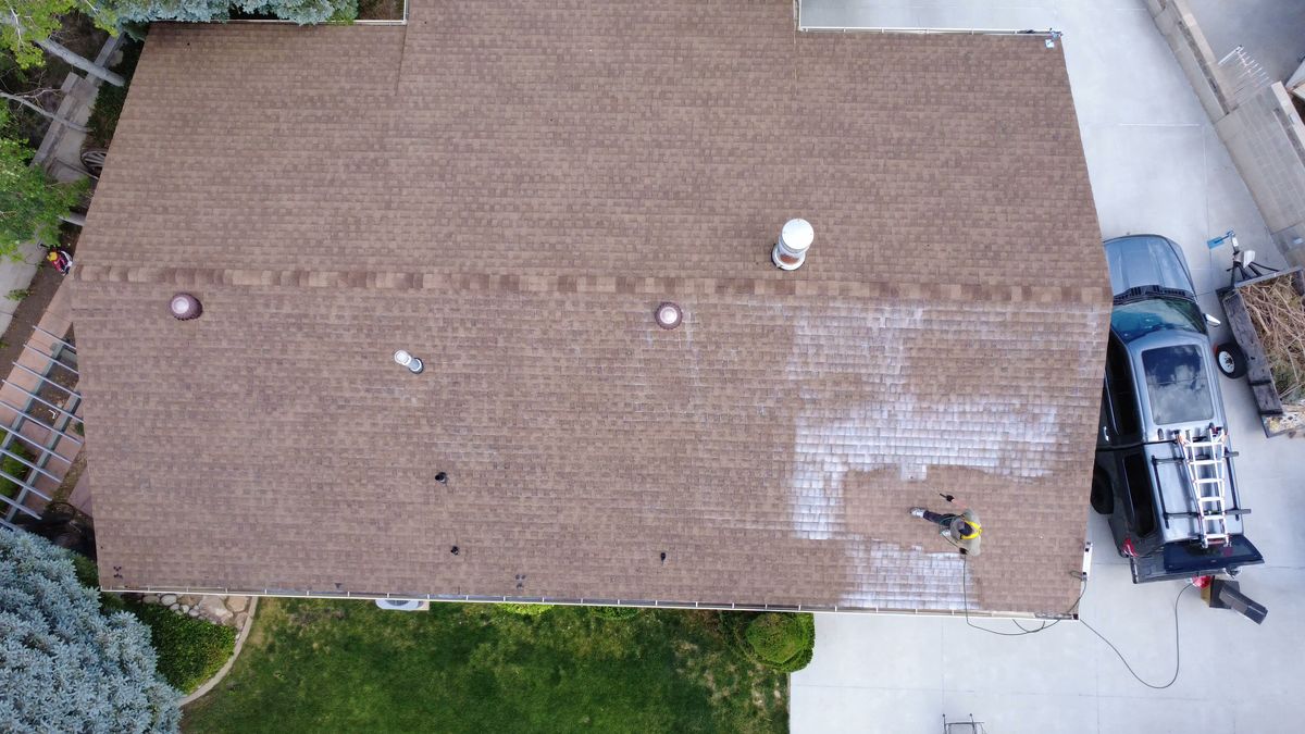 Overhead view of a large Utah roof being restored with the work van parked in the driveway