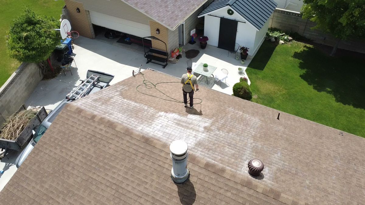 Overhead drone view of a Utah roof being inspected slope by slope