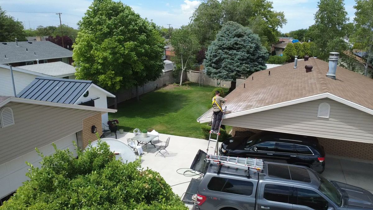 The Revive Your Roof van and ladder set up outside a Utah home